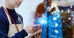 Person using a laptop with digital graphics showing a glowing brain labeled “AI” and floating icons related to technology.